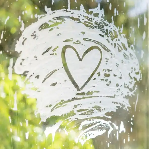 cleaning-08-ezgif.com-optiwebp soap suds on a window with a heart drawn